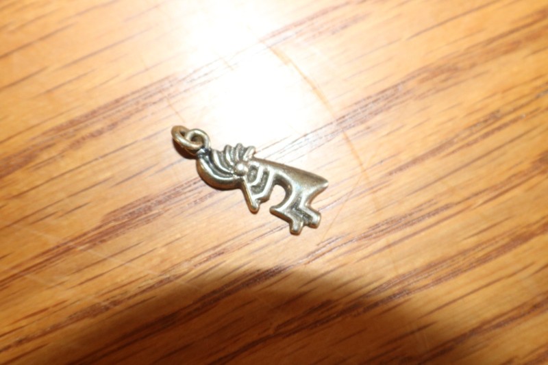 VINTAGE STERLING PERSON PLAYING A FLUTE WITH AVA AN A WITH A CROSS IN IT