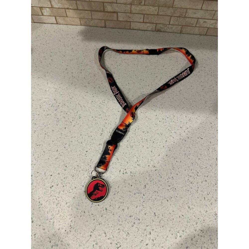 Seven Times Six Jurassic Park Logo Sticker and Rubber Charm 15" Long Lanyard