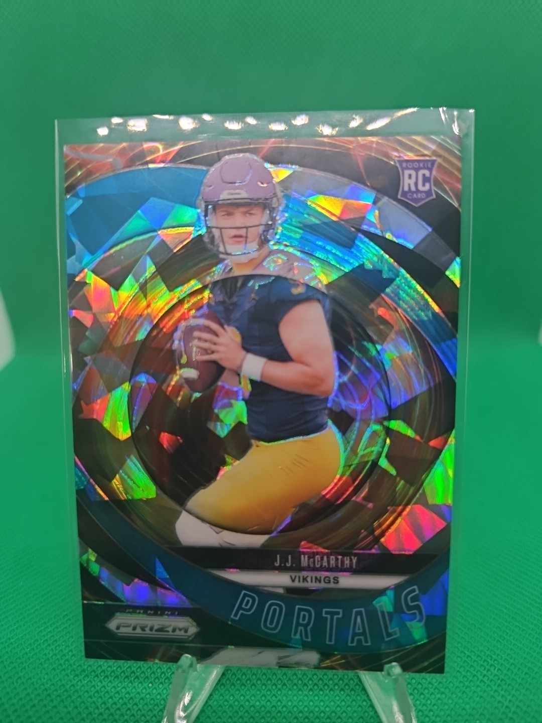 2024 Panini Prizm - Portals J.J. McCarthy #7 Blue Ice Prizm /99 (RC)