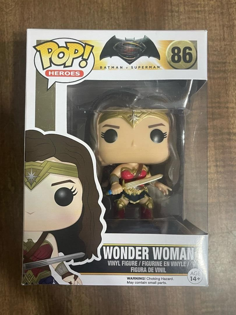 Three Wonder Woman Pop Vinyl Figures: #86, #86 WalMart Variant, #172 in red/gold armor.