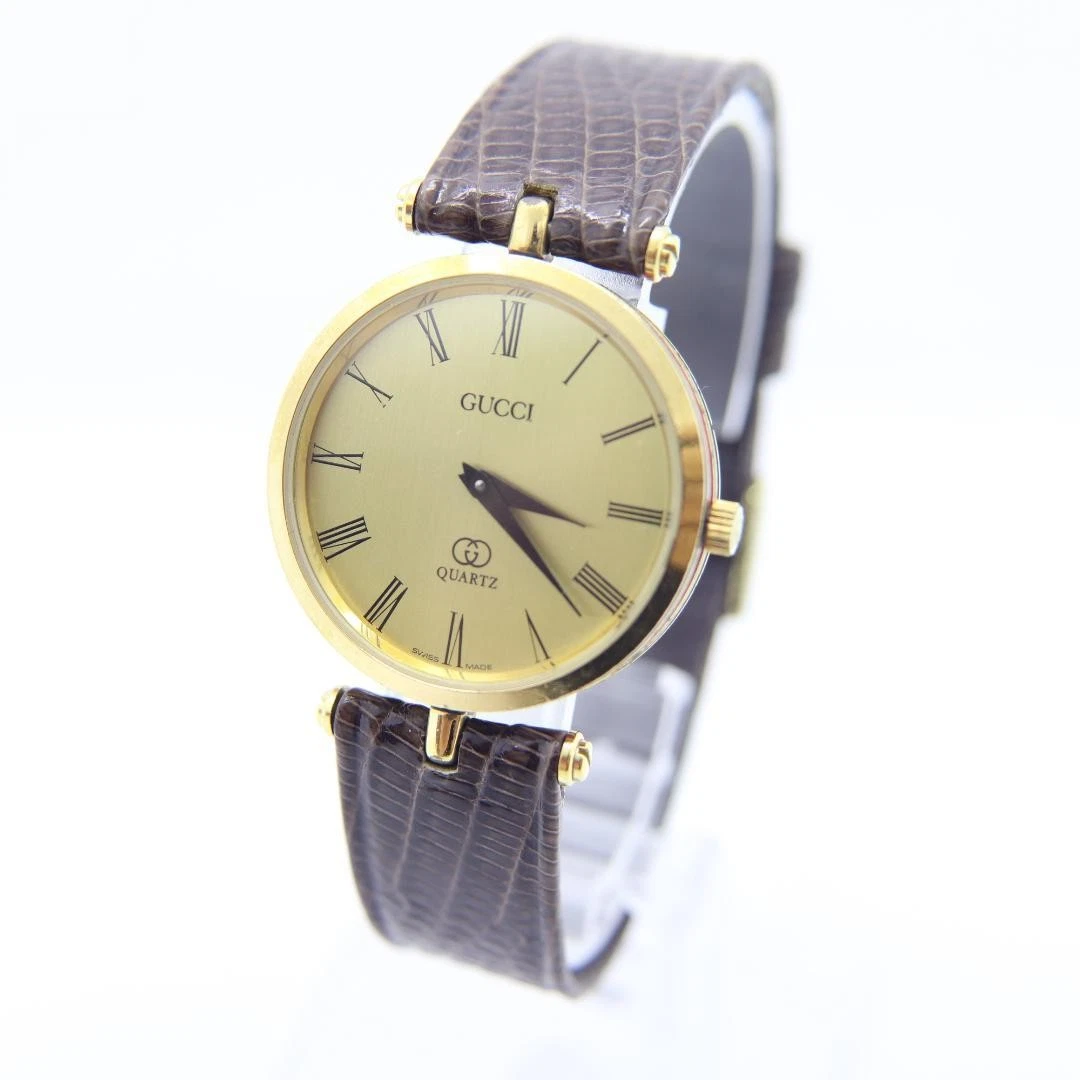 Montre Gucci Sherry Line vintage quartz ronde or homme 30 mm fabrication suisse