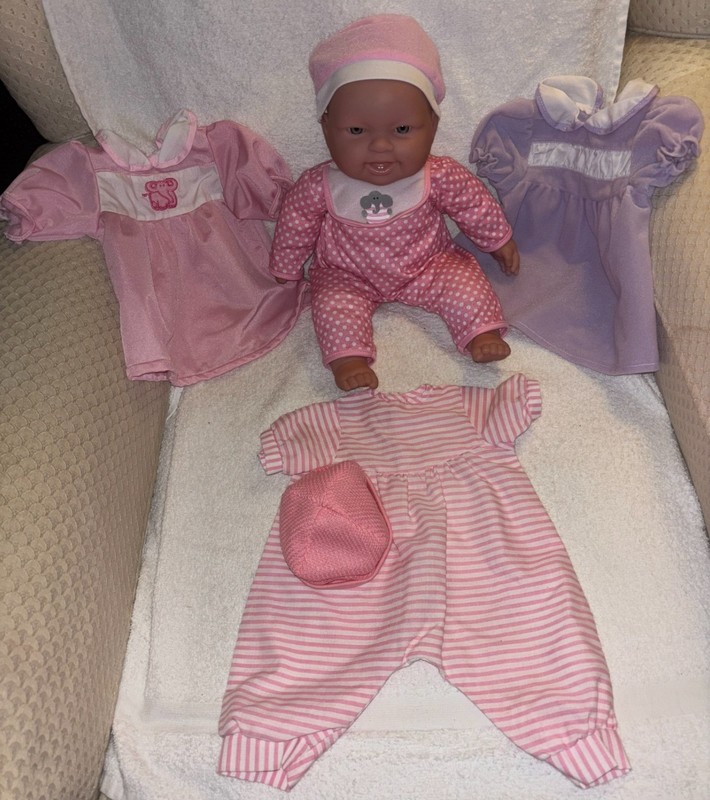 A 14" Life-like Baby Doll with 2 Dresses and a Pink & White Romper!