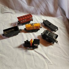 Vtg Tin Toy Wind Up Train Engine and an assortment of train cars.