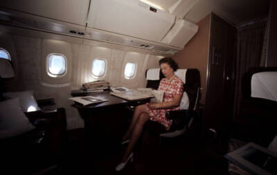 The Queen reading newspapers during her flight home from Bridg- 1977 Old Photo