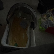 Gray and Yellow Oval Bassinet with Adjustable Canopy