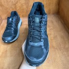 Black and gray New Balance 1540V2 men’s running shoes with mesh uppers, suede overlays, and gray laces, made in USA.