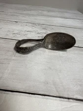 This is a vintage silver-plated baby spoon with a decorative handle.