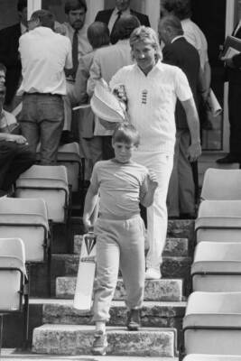 Englands Ian Botham walks out onto the field, preceded by - 1986 Cricket Photo