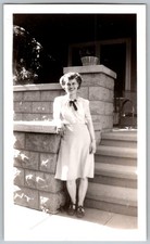 Vtg B&W Snapshot Smiling Woman In Blouse With Bow & Skirt On Porch Steps House
