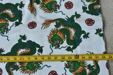 By 1/2 Yd, Green & Orange Fire Breathing Dragons on White Flannel, Marcus, P5381