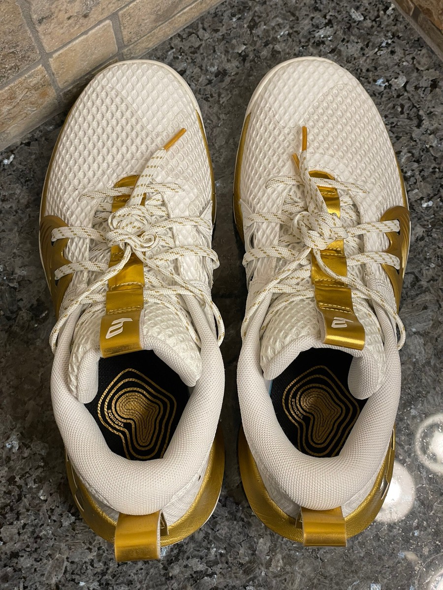 white and gold gym shoes
