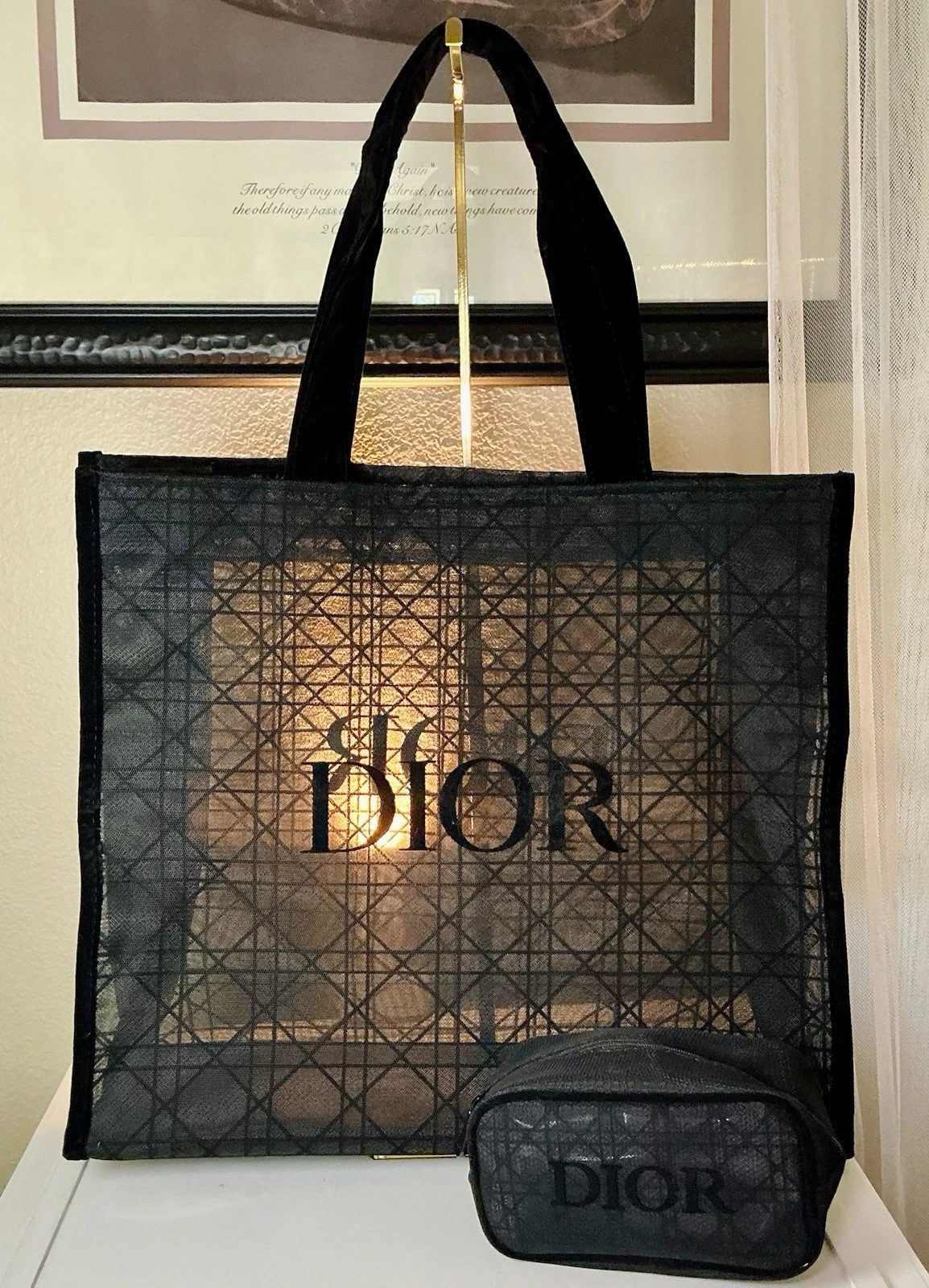 Black lace mesh tote with gold �DIOR� logo, black handles, and black zippered pouch with gold �DIOR� text.