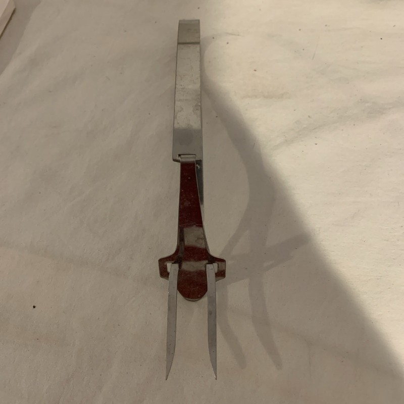 Vintage hinged mechanical stainless steel serving fork 