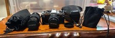 Olympus OM 10 Single Lens Reflex Camera with 35 70 and 100 200 Telephoto Lenses
