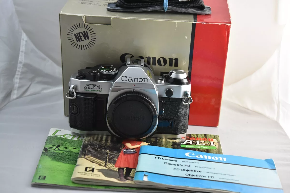 Canon AE-1 Program, mint, includes box, manual and paper works