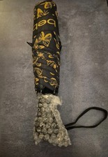 Bebe compact umbrella featuring a black and yellow butterflies.