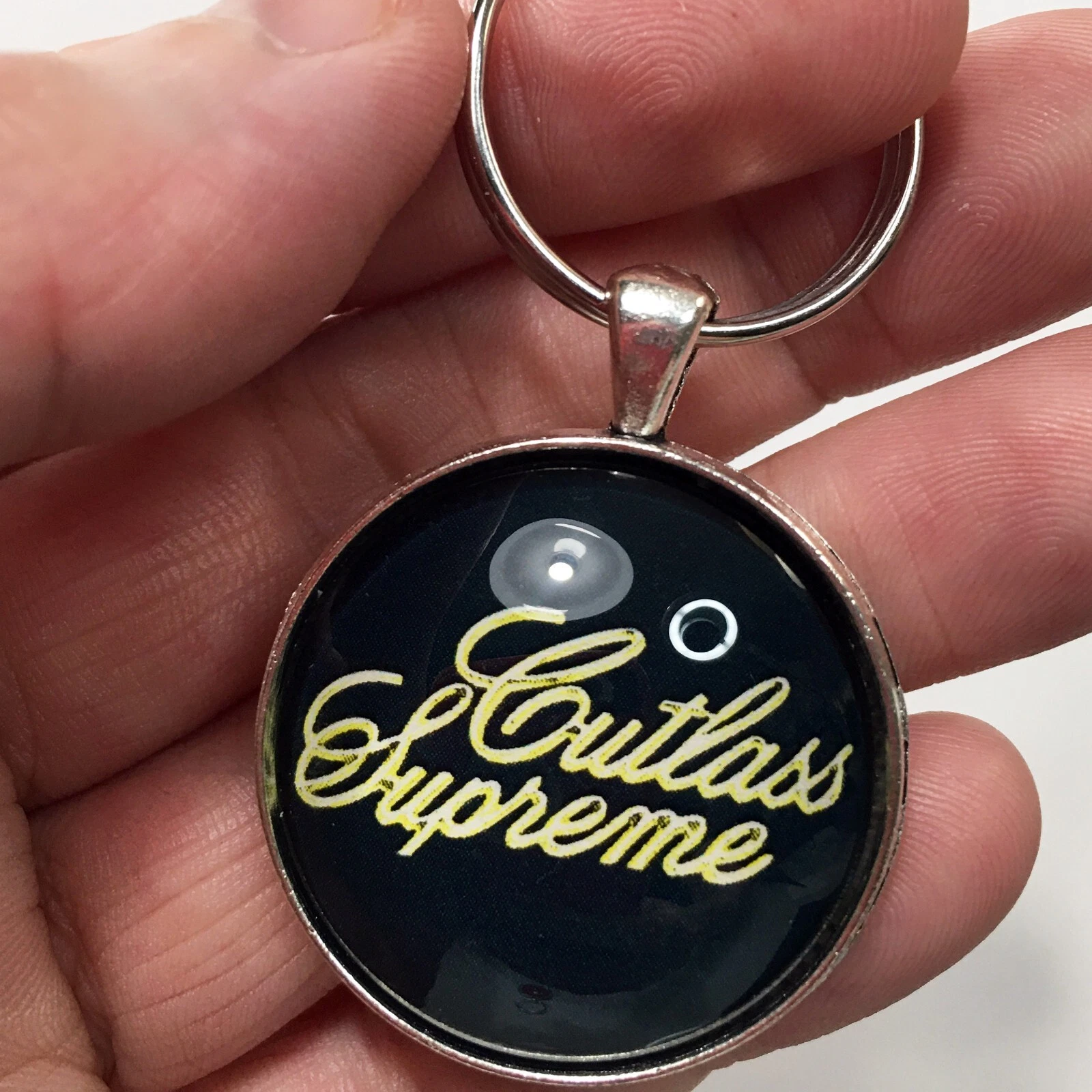 Porte clés vintage GM Oldsmobile or cutlass emblème suprême badge logo