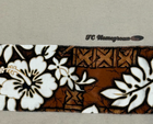 Brown and beige Y2K VTG T&C surf shirt with white hibiscus floral pattern and “TC Homegrown” logo on sleeve.