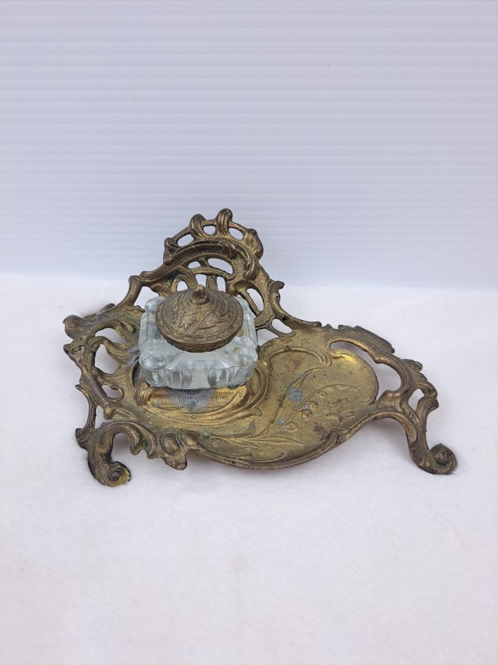 A complete Art Nouveau brass writing desk set with glass inkwell — the kind of thing a Victorian novelist would have used, still in good condition.