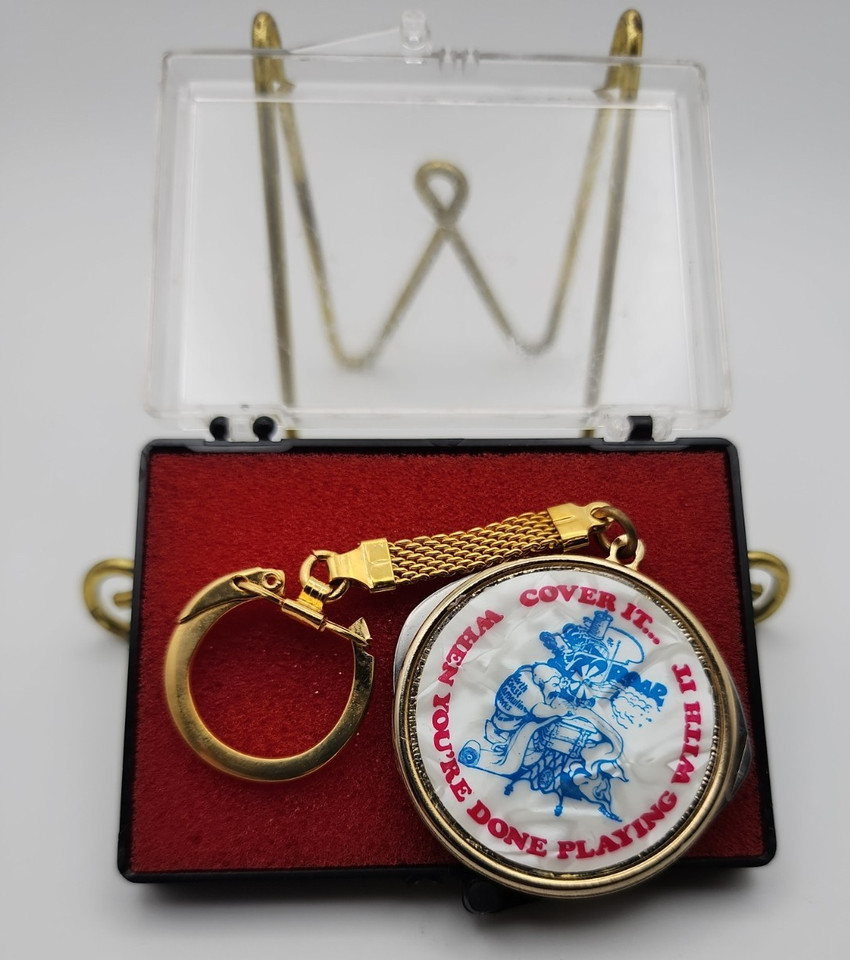 A 1970s automotive advertising keychain folding tool — pocket-sized retro cool with a car-culture backstory baked right in.