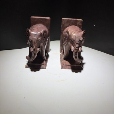 A pair of vintage carved marble elephant bookends with rectangular bases.