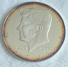 8 Troy ounce Kennedy Half Dollar.  .999 silver,  3.5 inch diameter.