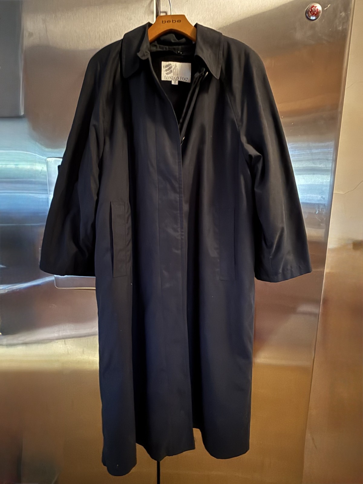 Black long trench coat on a hanger