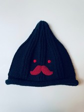 Very dark navy almost black kid's beanie with red embroidered mustache face.