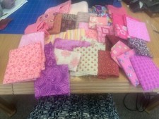 Mixed lot of scrap pink fabric - various sizes - approx 2 pounds in weight