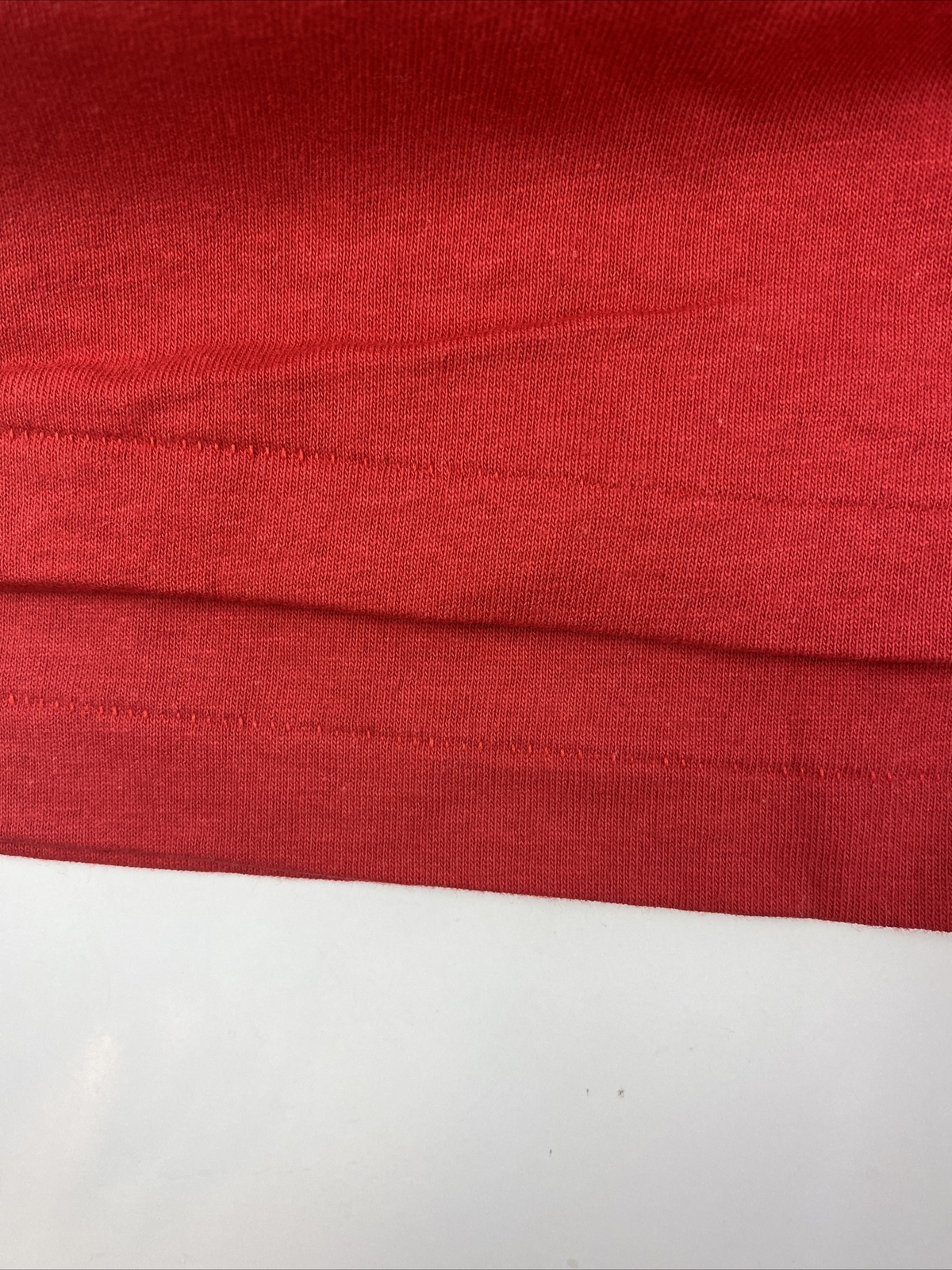 Folded red vintage Disneyland Mickey Mouse T-shirt with single stitch, white background, and USA Made label on collar.