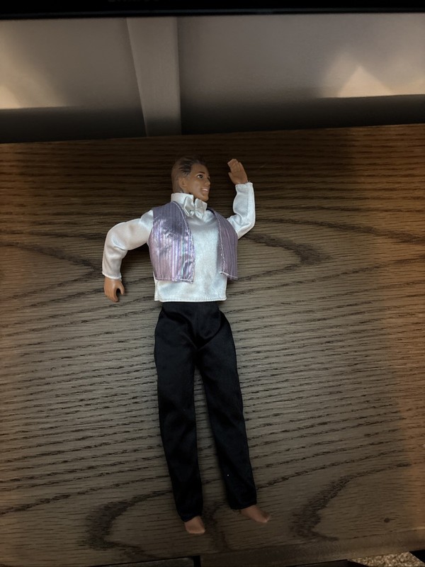 Mattel Barbie Ken doll wearing a formal silver and black tuxedo