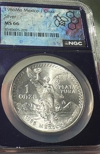 1986 Mo Mexico 1 Silver Onza, NGC Graded: MS 66 TRADER Bea purple Core  