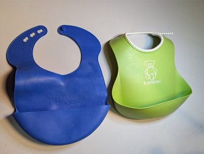 BIB LOT (2) - One Tommee Tippee Mess Catcher And a BabyBjorn Washable Bibs
