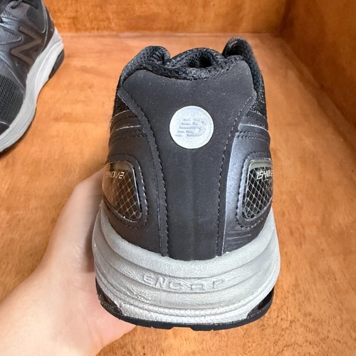 Black and gray New Balance 1540V2 men’s running shoes with silver logo, mesh upper, and rubber sole, made in USA.