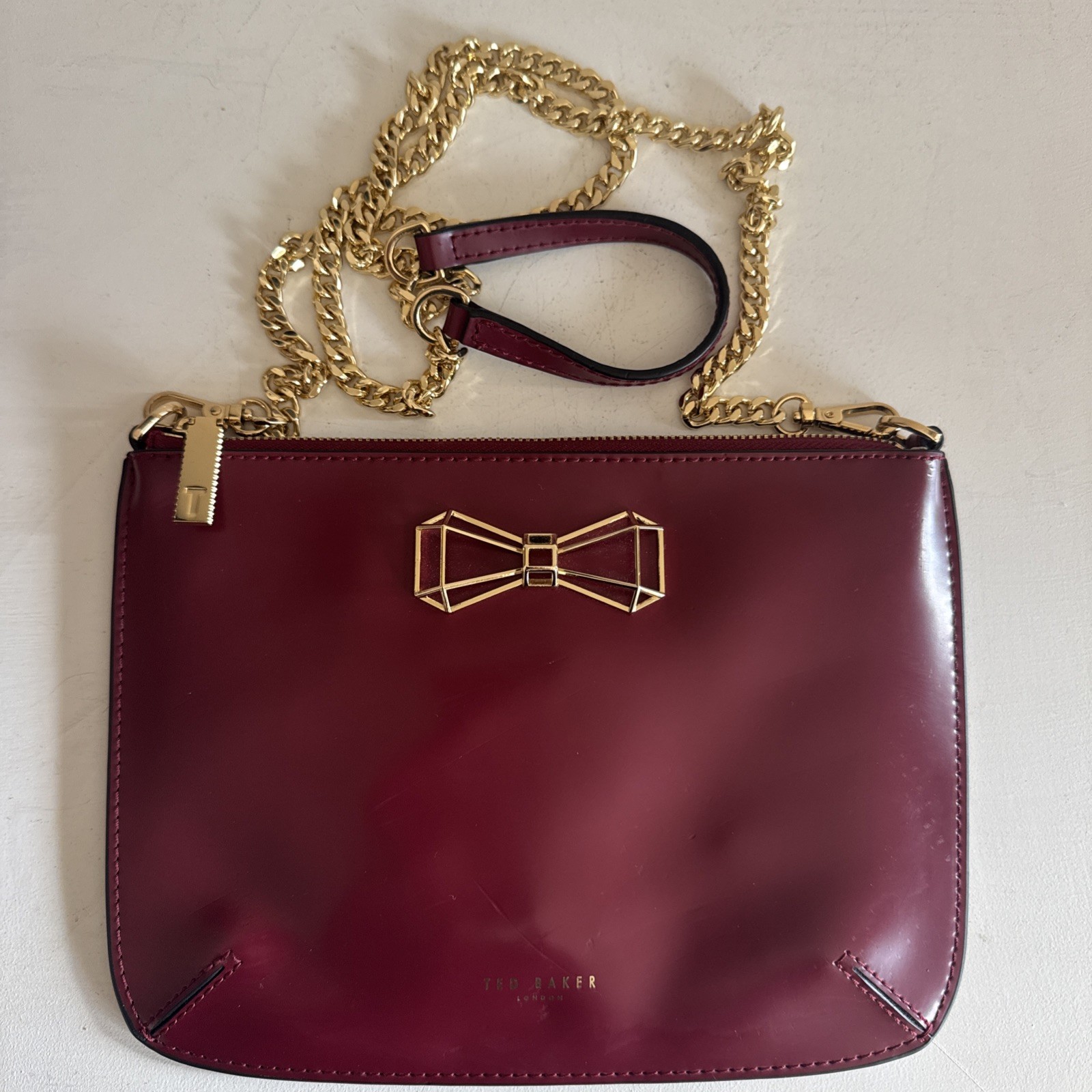 Ted Baker GRETAA Geometric Bow Leather Crossbody Oxblood Red Maroon Gold Strap