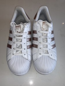 white adidas with rose gold stripes