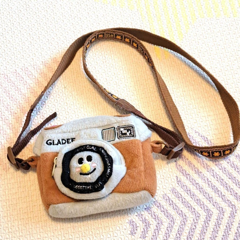 A quirky Heisei-era Japanese camera bag with a fleece face motif — genuinely one-of-a-kind Harajuku-meets-utility weirdness.