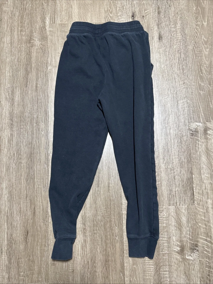 Pantalones deportivos Under Armour niñas jóvenes medianos negros calce holgado Foto 2 de 4