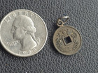 bronze tone metal coin pendant charm with square hole and bail loop — photo 1