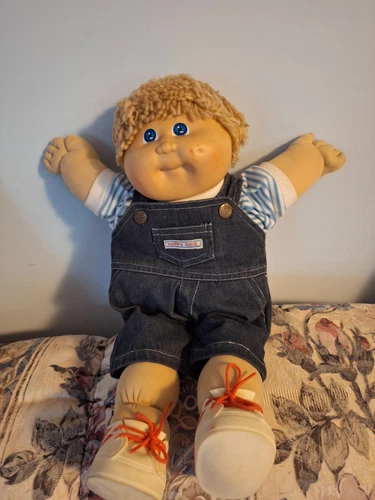 Cabbage patch doll with blue jean overalls, blue striped shirt, shoes