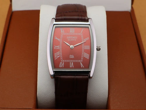 Vintage Seiko Slim Quartz Men's Wrist Watch Red Dial with Dark Brown strap.