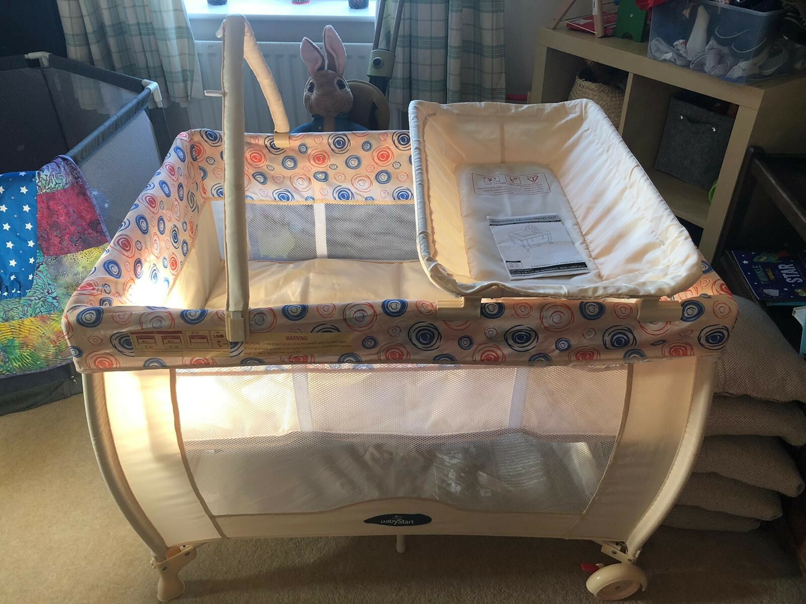 cream travel cot
