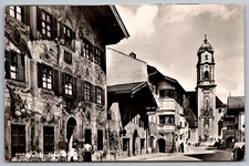 Street View with Painted Building and Church Tower in Antique Postcard