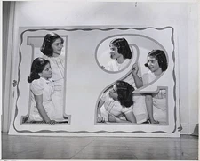 The Dionne quints exchange greetings through a big cutout prepared- Old Photo