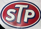 vintage-style STP motor oil advertisement metal sign