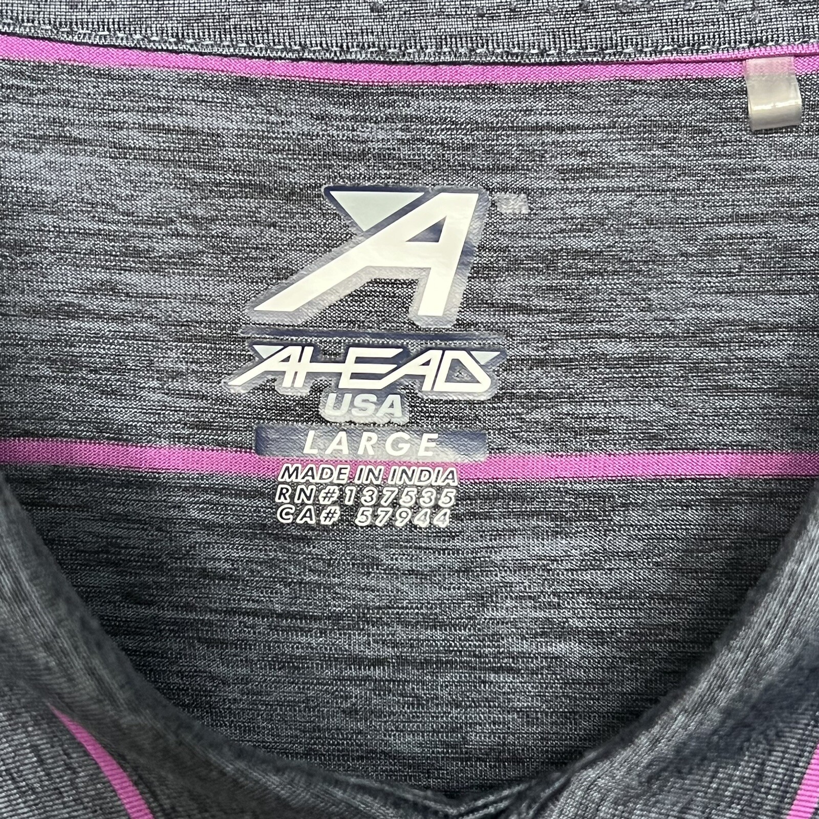 Gray and pink striped polyester polo shirt with “AHEAD USA LARGE MADE IN INDIA” label and white logo on chest.