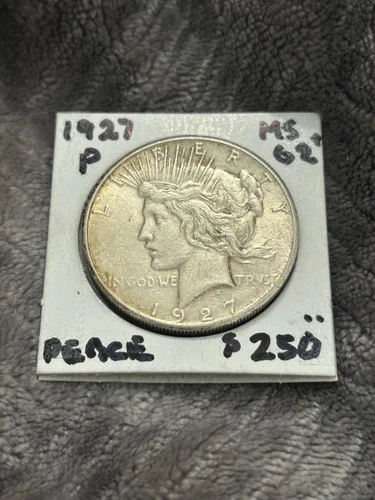 UNC 1927-P SILVER PEACE DOLLAR. Looks Choice, lightly toned with muted luster.