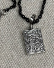 The World tarot card pendant necklace with a black chain