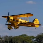 Yellow E-flite RC airplane UMX WACO with black trim, silver propeller, and AS3X and SAFE EFLU53550Y branding.