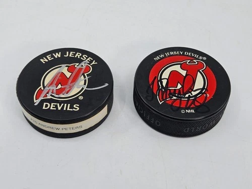Lot 2 New Jersey Devils Autographed NHL Hockey Pucks Andrew Peters Sergei Brylin